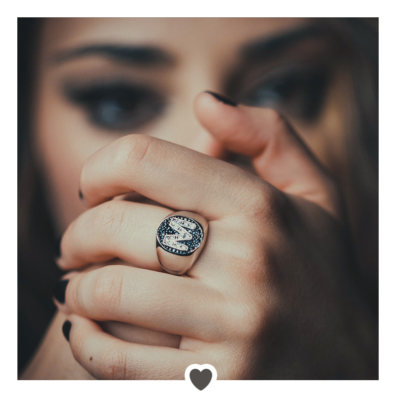 Ragazza indossa un anello da mignolo in argento con lettera M